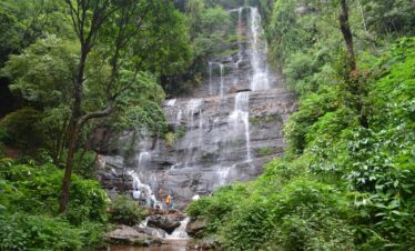 Beautiful waterfall cascading through lush greenery in Chikmagalur, India.