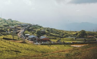 Peaceful countryside scene with hills, trees, and road in Chikkamagaluru, India.