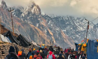 Explore the lively streets of Kedarnath with stunning Himalayan backdrop, capturing the essence of local life.