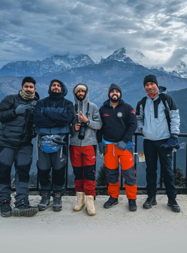 Group of trekkers enjoying a winter hike in Ghode Pani, Nepal with majestic mountain views.